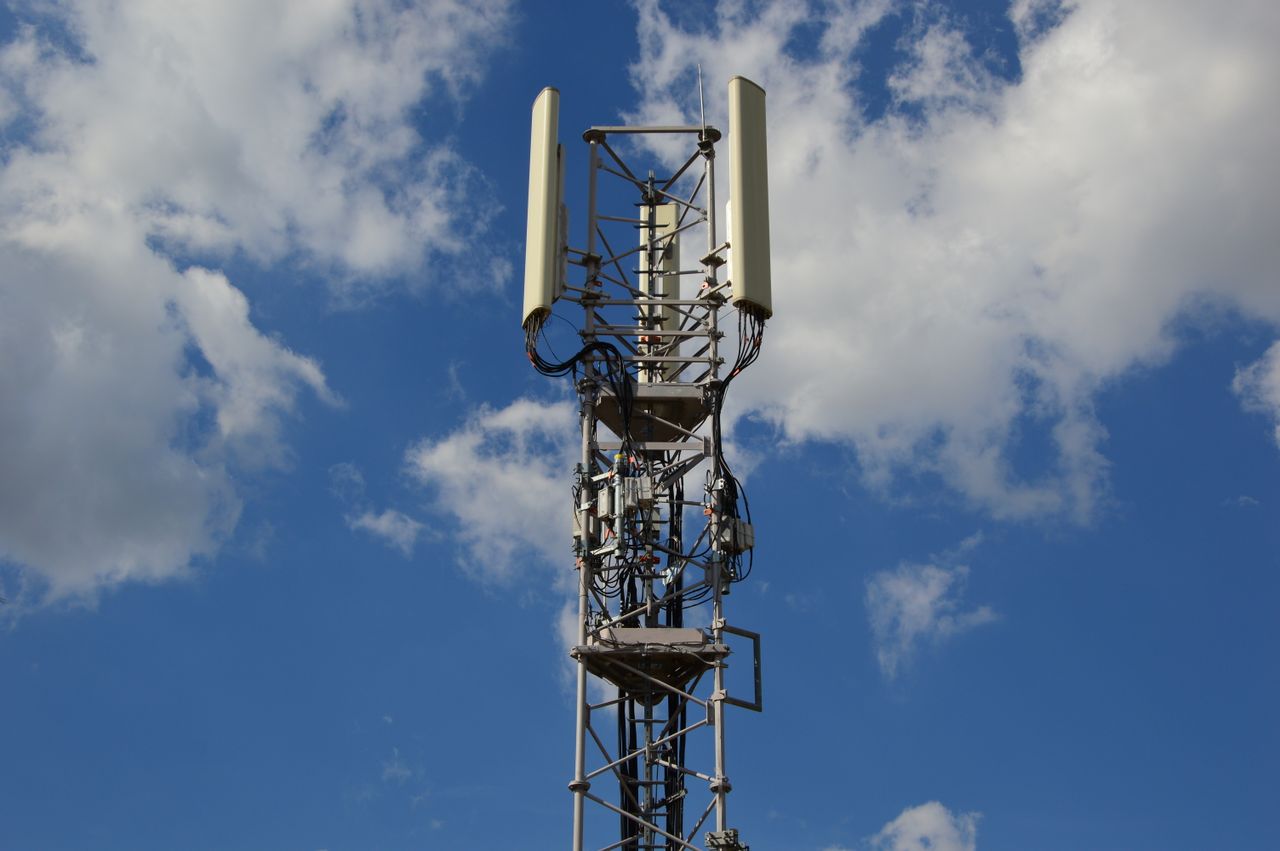 why-choose-us A tall cellular communication tower against a vivid blue sky, symbolizing modern technology.